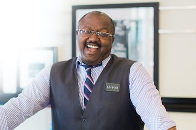 Front desk clerk smiling 