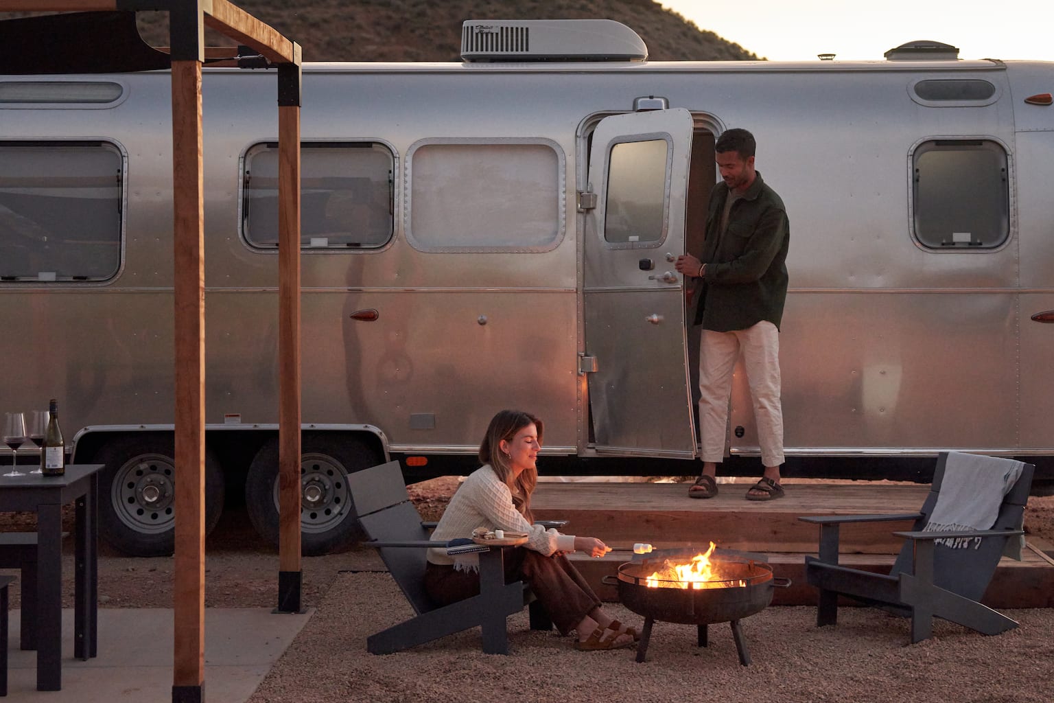 Two people by a campfire